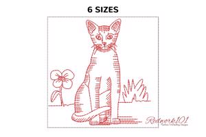 Abyssinian cat sitting with flower